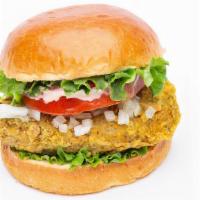 Crispy Chickin Sandwich · Vegan. Crispy chickin,  tomato, lettuce, chopped onions, house-made sauce, and potato buns.