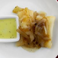 Yuca Con Mojo · Boiled cassava, a potato-like vegetable with cabana's signature mojo sauce.