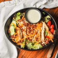 Incredible Chargrilled Chicken Salad · Grilled marinated teriyaki chicken breast served over crisp greens topped with shredded chee...
