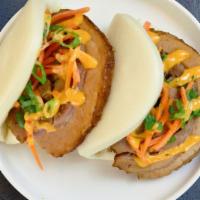 Bao Bun Pork · Steamed bao buns with pork belly, scallions, carrots, Hoisin sauce and spicy mayo. 2 units.