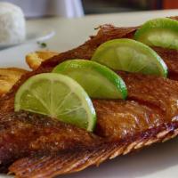 Mojarra Frita Con Arroz Y Tostones Grande · Fried snapper with rice and fried green plantains.