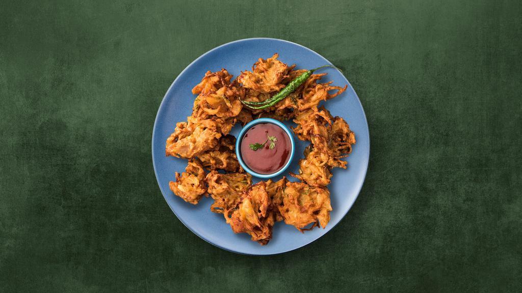 Crisp Onion Fritters · A medley of onions dipped in chickpea and rice flour batter and deep-fried till crispy and golden color. Served with mint or tamarind relish