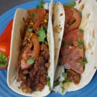 2 Pack Vegan Tacos · Served with lettuce tomatoes onions cilantro and vegan cheese.