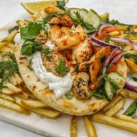 Pork Gyro · Rotisserie roasted pork, tzatziki, Greek salad, fries on a homemade pita and feta.