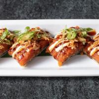 Crispy Spicy Tuna · minced tuna mixed with spicy aioli, sesame oil, and dry chili over crispy rice, topped with ...
