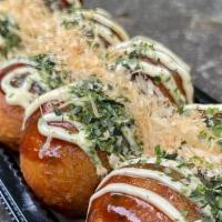 Takoyaki · popular stret food from Osaka with bits of octopus and dough inside a slightly crispy shell,...