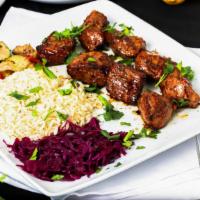 Lamb Shish Kebab · Lamb tenderloin cubes, white rice, red cabbage, sautéed vegetables.