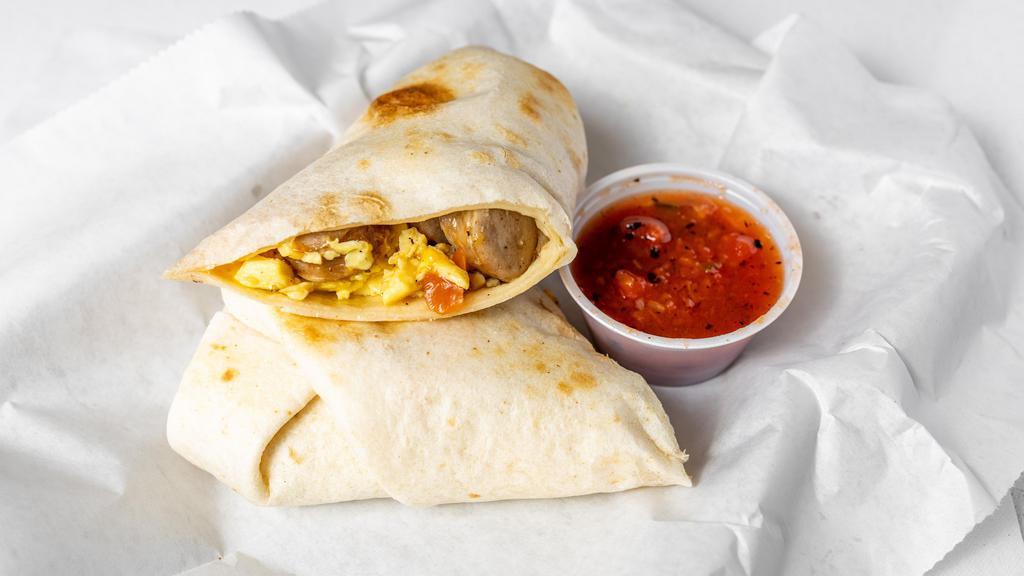 Breakfast Burrito · Choice of bacon or sausage in a tortilla wrapped with scrambled eggs, crispy potatoes, sautéed pepper and onion mix, and cheddar cheese