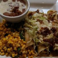 Chicken Enchiladas · Chicken, cheese, creamy tomatilla sauce, Jalapeno corn and black beans.