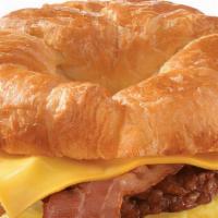 Croissant, Bacon, Sausage, Egg & Cheddar · 2 scrambled eggs, melted Cheddar cheese, smoked bacon, breakfast sausage, grilled onions, an...