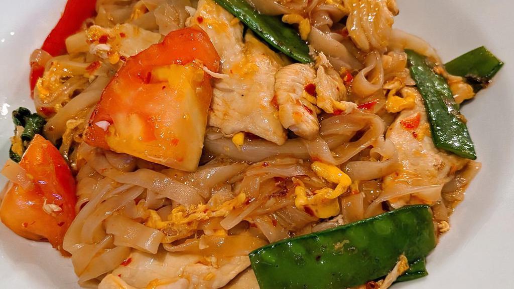 Drunken Noodle · Stir fried egg with rice noodles, chopped garlic, chili sauce, tomatoes, onions, bell peppers, snow peas, and basil. Spicy.