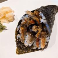 Salmon Skin Roll · Baked salmon skin, scallions, and sesame seed seaweed outside.