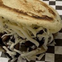 Black And White · Exquisitely toasted arepa with black beans and white cheese.