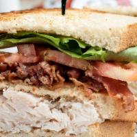 Bacon & Turkey Club · A large serving of fresh sliced turkey breast and strips of crisp bacon, lettuce, and tomato...