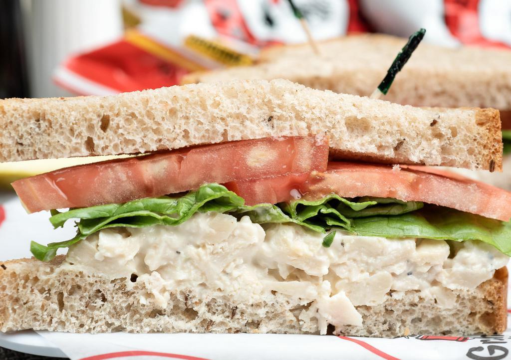 Chicken Salad Sandwich · Four ounce serving of fresh made hearty chicken salad. Made-to-order on your choice of bread, served with lettuce and tomato, Groucho's famous potato chips, and a dill pickle spear.