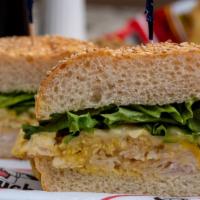 S.M. White Moose · Fresh sliced turkey breast, melted swiss topped with lettuce and formula “95” dressing on a ...