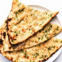 36 Garlic Naan · Leavened white flour baked in clay oven.