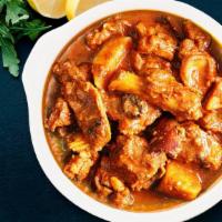 Goat Vindaloo · Fiery marinated goat cooked in highly flavorful spicy mixture and vinegar.