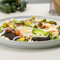 Huevos Rancheros​ · Two sunny side-up eggs covered with a spicy tomato sauce with refried beans, avocado, fresh ...
