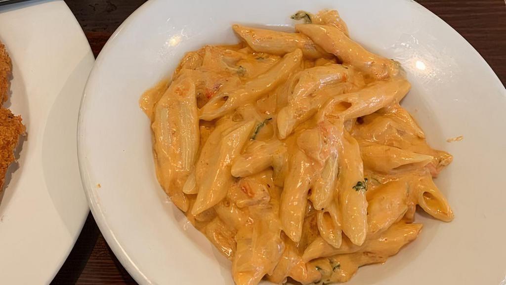 Pasta With Vodka Sauce · Penne alla vodka is a pasta dish made with vodka and penne pasta, usually made with heavy cream, crushed tomatoes, onions, and peas.