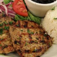 Combo 5 · 1/2 lb. pork loin. Served with rice, black beans, and an extra side.