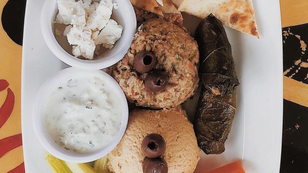 Mediterranean Platter · Baba ganouj and garlic hummus. Served with 2 stuffed grape leaves, carrots, celery, feta cheese, olives, tzatziki sauce and toasted pita bread.