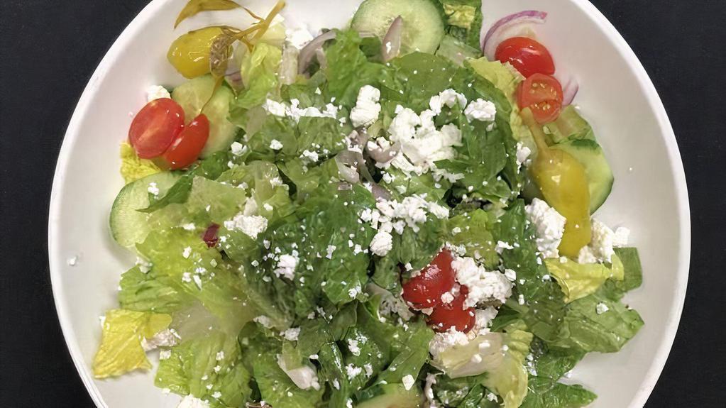 Greek Salad · Romaine lettuce, tomatoes, cucumbers, olives, pepperoncini's, red onion, Feta cheese, white balsamic vinaigrette.