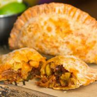 Oxtail Empanadas · Signature Item. Braised oxtail, manchego, golden raisins, chimichurri.