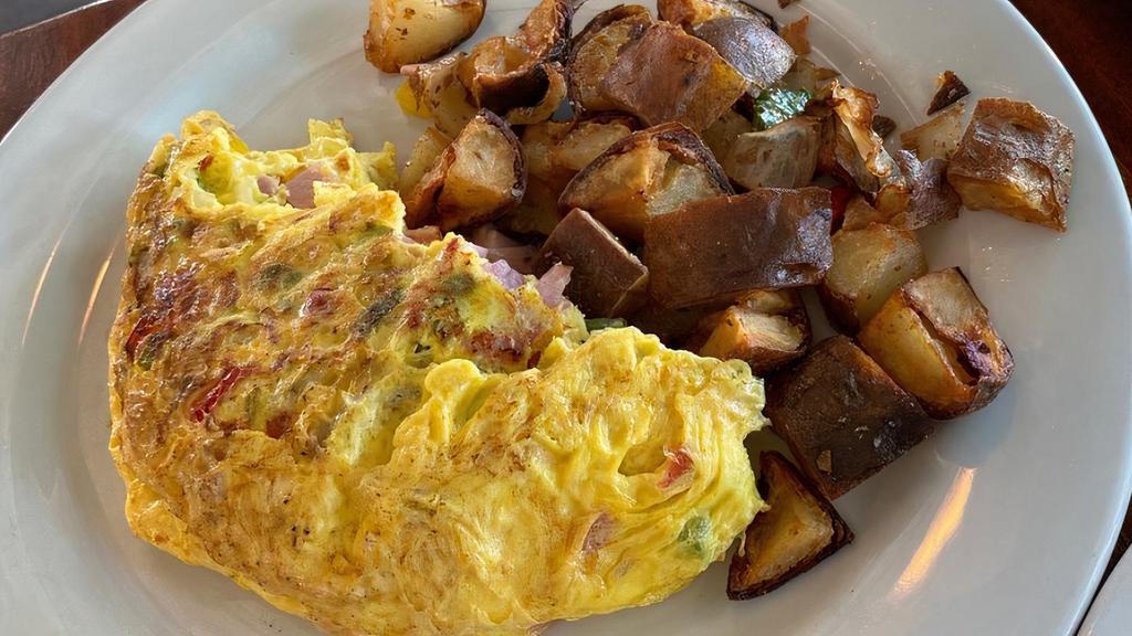 Western Omelette · Ham, red and green peppers, onions, and cheddar cheese. Served with multi-grain toast and home fries.