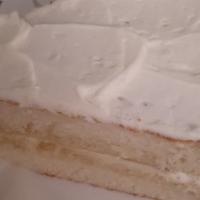 White Cake With Buttercream Icing · A slice of delicious white cake with a creamy buttercream frosting.