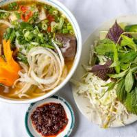 Spicy Hue Noodle Style / Bún Bò Huế · Thick vermicelli rice with a beef flank. Beef, brisket, beef shank, pork patty, pig feet, an...