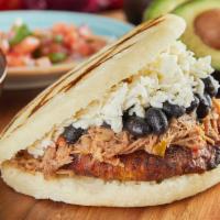 Arepa Pabellon · Shredded beef, black beans, sweet plantains and paisa cheese.