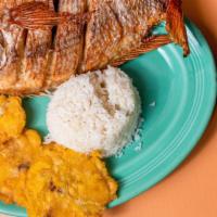 Mojarra Frita · Fried mojarra fish with two side dishes.