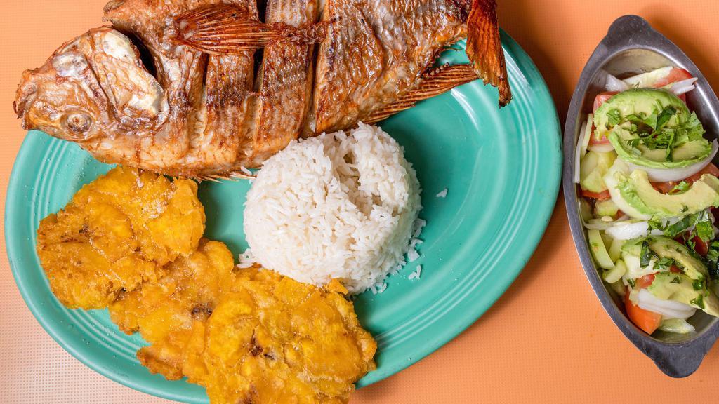Mojarra Frita · Fried mojarra fish with two side dishes.