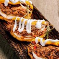Las Cachapas Con Mechada · Trio of Venezuelan style sweet corn pancakes filled with queso e' mano, shredded beef and to...