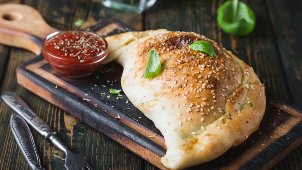 Spinach Calzone · Crisp, savory calzone filled with fresh spinach, ricotta, and mozzarella cheese.