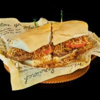 Pan Con Bistec Sandwich · Thin sliced grilled steak, grilled onions, tomatoes, and string potatoes on Cuban bread.