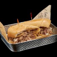 Pan Con Lechon Sandwich · Grilled pork, onions and mojo sauce on Cuban bread.