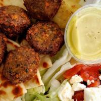 Falafel Platter · Fried ground chickpeas with herbs. Served over pita with a side Greek salad, Greek fries, an...