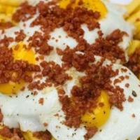Broken Eggs · Three sunny side up eggs on a bed of french fries, top it off with spanish sausage.. 

Consu...