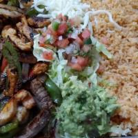 Fajita Plate · Chicken or steak stripes mix with green peppers and onions, rice, pinto beans topped with qu...