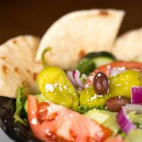 Grecian Salad · Lettuce, tomatoes, onions, cucumbers, olives, pepperoncini, feta, and grilled Pita bread