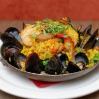 Paella · Mussels, shrimp, chicken, chorizo, peas, peppers, onions, tomatoes, saffron rice.