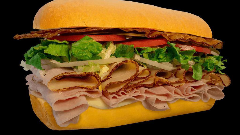 #6 American Club · Ham, Turkey, Bacon, & Provolone Cheese on White Roll.