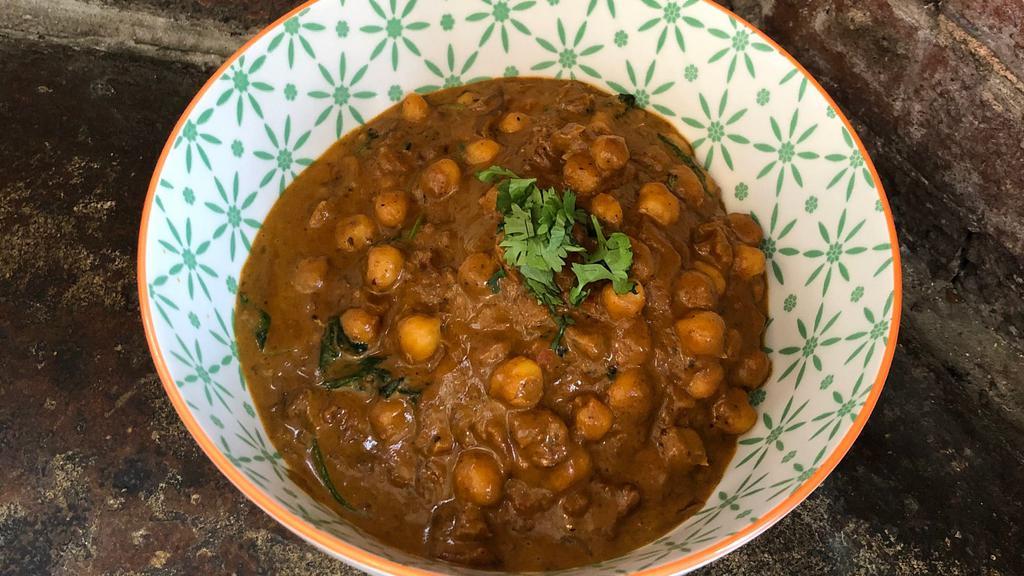 Chickpea And Spinach Masala - India · Mild & traditional...smoky, slow-cooked tomato based curry sauteed with chickpeas & spinach served over jasmine rice