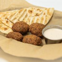 Falafel & Pita · Falafel is a deep fried ball or a flat or doughnut shaped patty made from ground chickpeas, ...