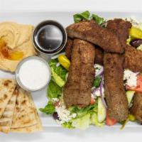 Mediterranean Platter · Gyro meat over Greek salad. Served with pita and sauce.