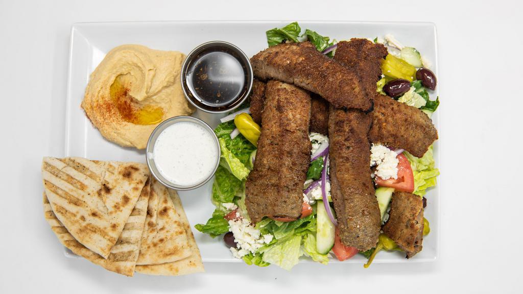 Mediterranean Platter · Gyro meat over Greek salad. Served with pita and sauce.