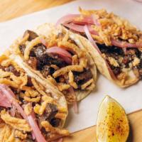 El Veggie (3 Tacos) · Confit mushrooms, roasted garlic, pickled onion and crispy onion.