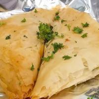 Spanikopita · Baked, flaky phyllo dough stuffed with a mixture of spinach, herbs, and six cheeses